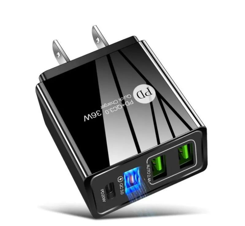 A black 4-port USB fast charging head plugged into a wall socket, with cables connected.