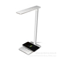 Black and white wireless charging desk lamp with touch controls and aluminium shade.