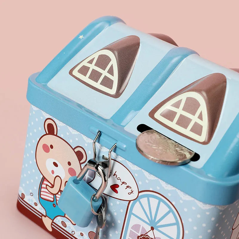 Blue tinplate house-shaped piggy bank with coin slot lid on wooden desk