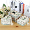Ceramic jewellery and tissue storage box in bright apricot colour on a wooden surface.