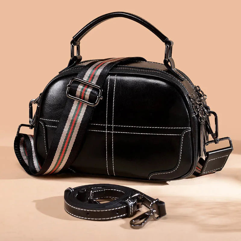 Round leather handbag with soft double handles and zipper closure in five colour options