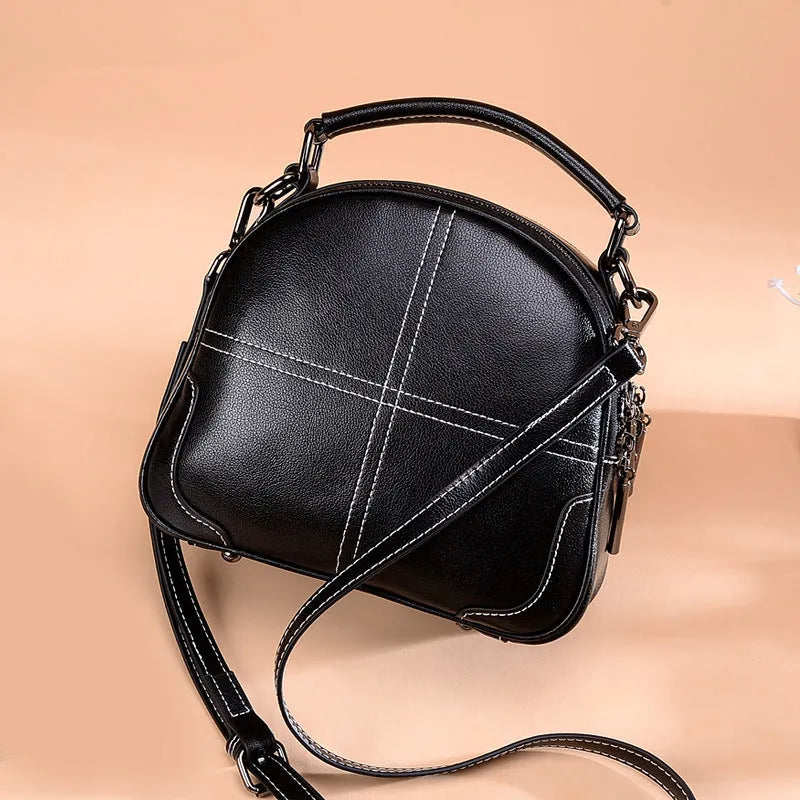 Round leather handbag with soft double handles and zipper closure in five colour options