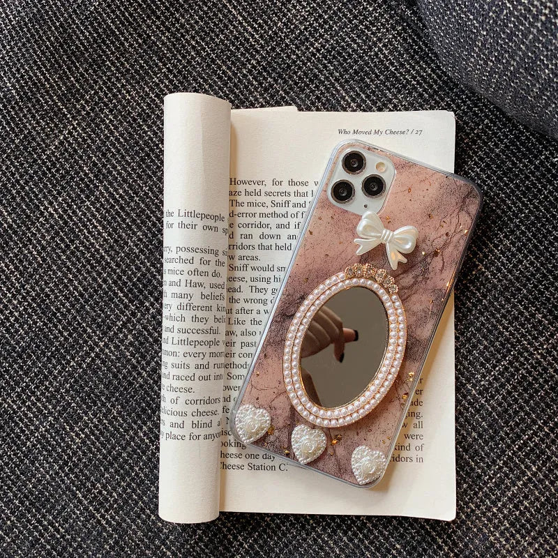Brown marble patterned silicone iPhone case with rhinestone mirror and bowknot design.