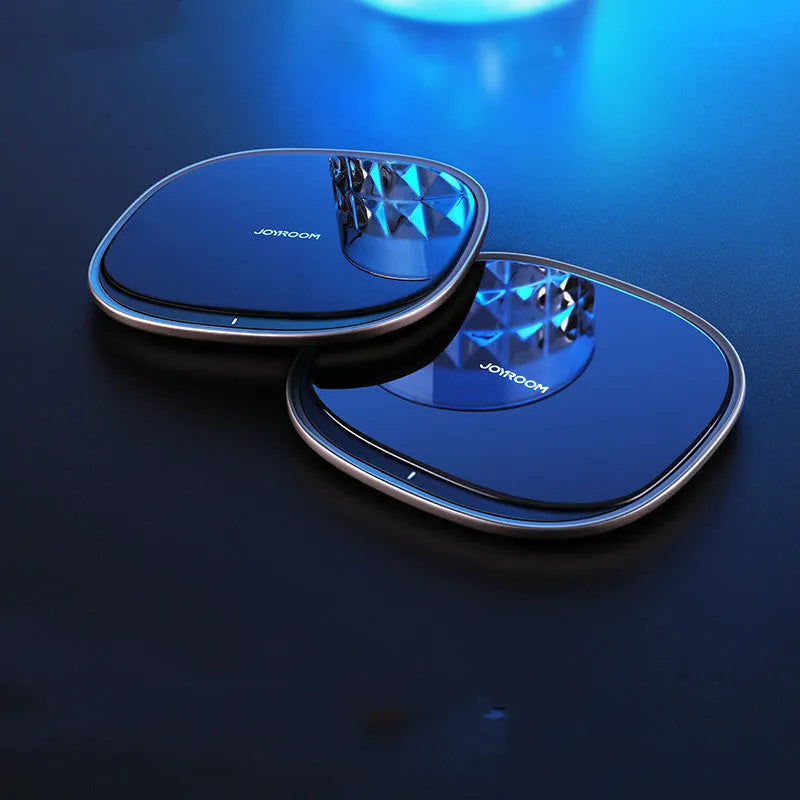 Black 15W wireless phone charger with glass top and zinc alloy body on a desk