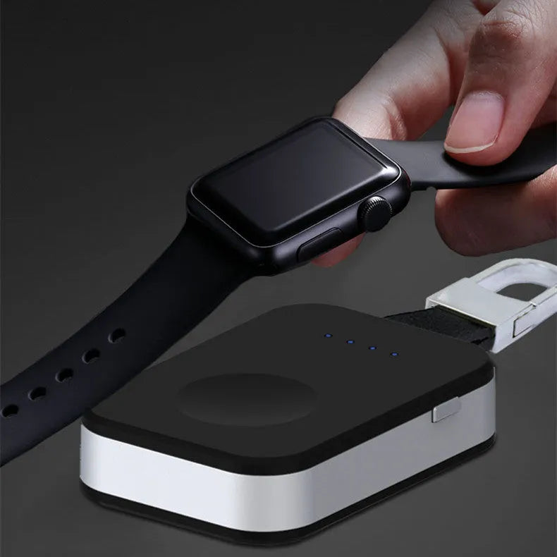 Black Apple Watch portable wireless charger keychain with USB port on a keyring.