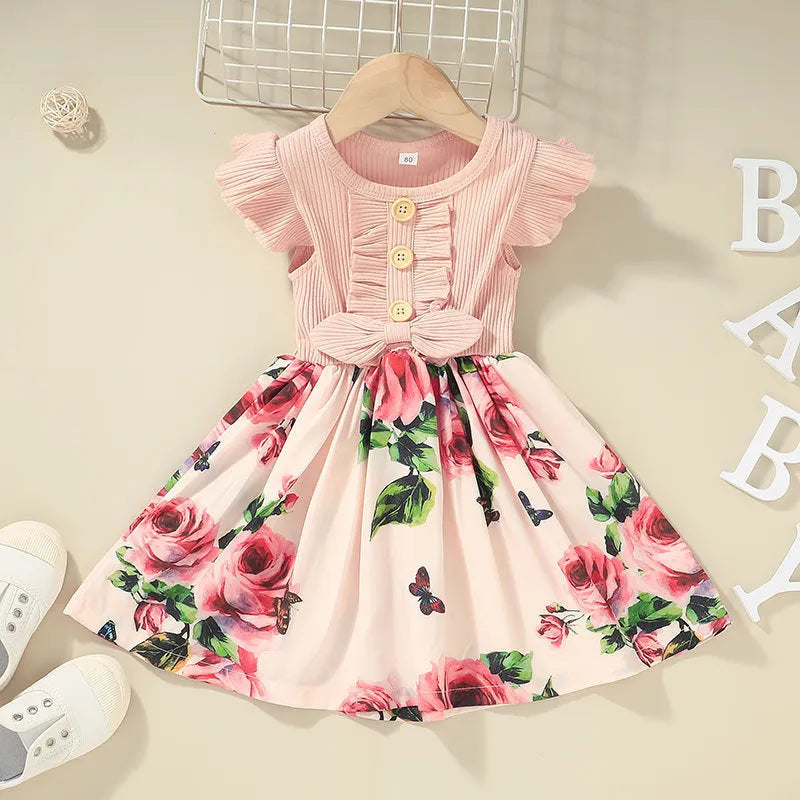 Toddler girl in a sleeveless summer dress, shown in one of six available colours including green, black, or pink.