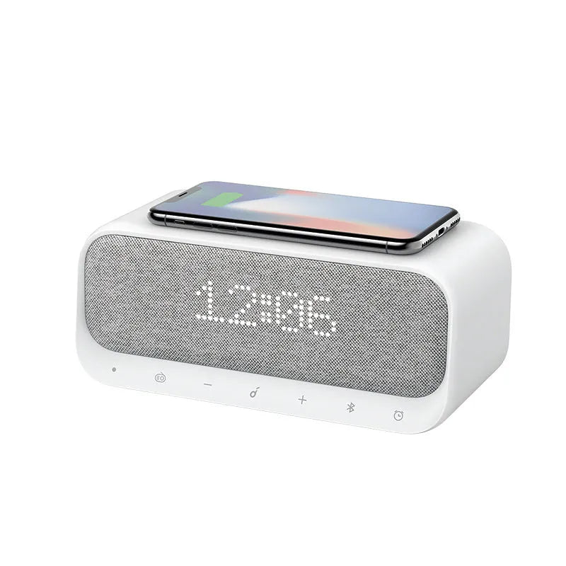 White or pink Anker Soundcore Bluetooth speaker with wireless charging top, display, and compact rectangular design