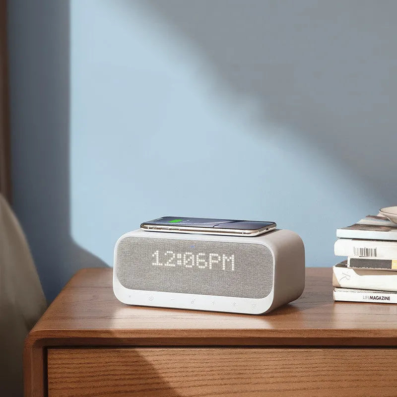 White or pink Anker Soundcore Bluetooth speaker with wireless charging top, display, and compact rectangular design