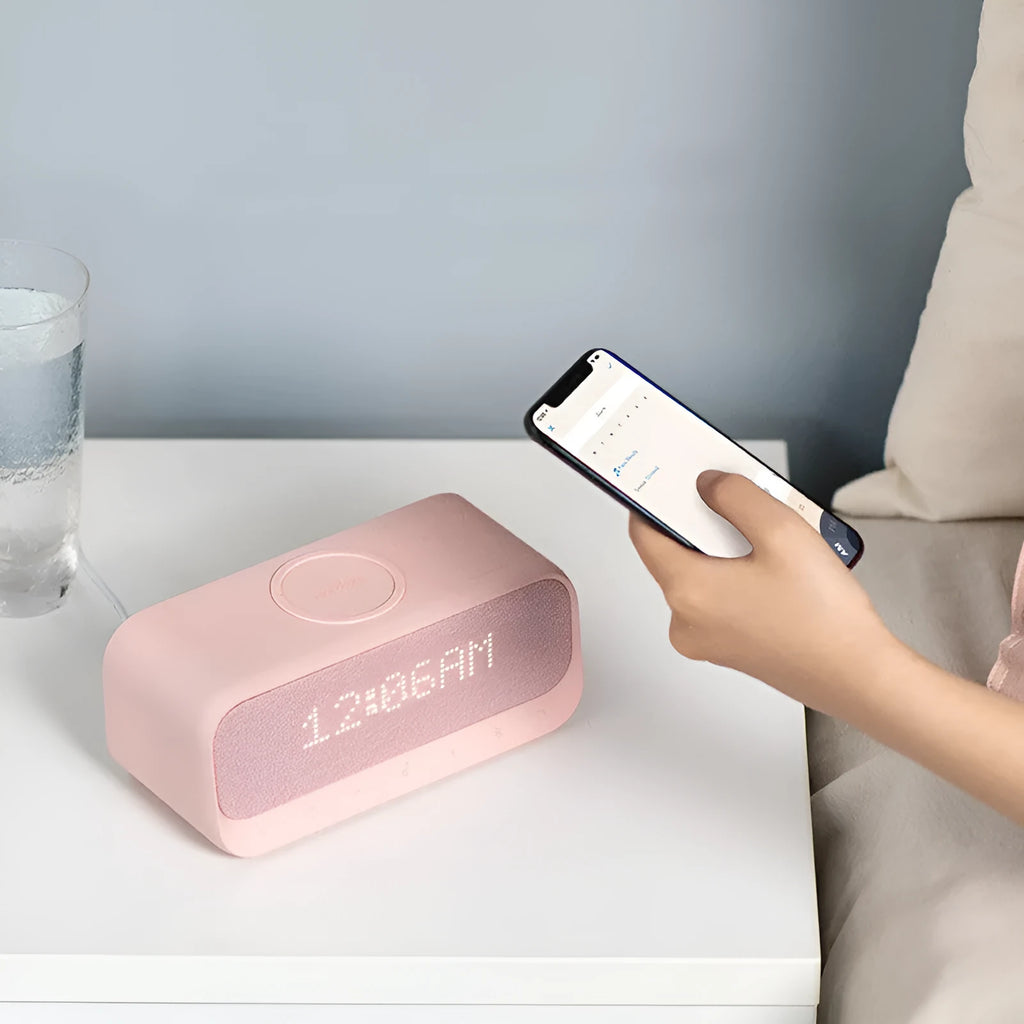 White or pink Anker Soundcore Bluetooth speaker with wireless charging top, display, and compact rectangular design