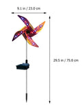 Solar wind spinner light with LED illumination spinning on lawn at dusk, showing IP65 waterproof aluminium and ABS construction