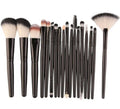 MAANGE 18 piece makeup brush set with fan-shaped brushes laid out on a table.