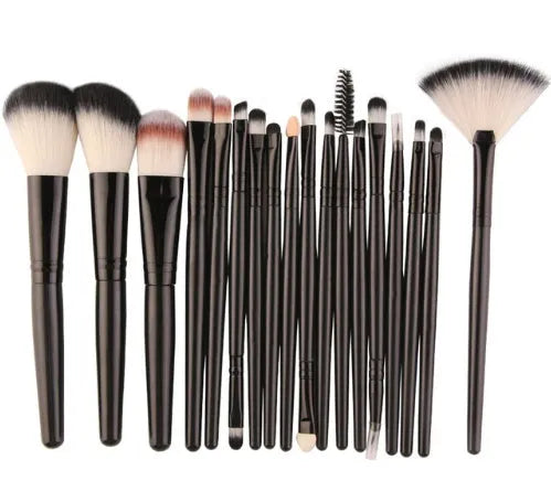 MAANGE 18 piece makeup brush set with fan-shaped brushes laid out on a table.
