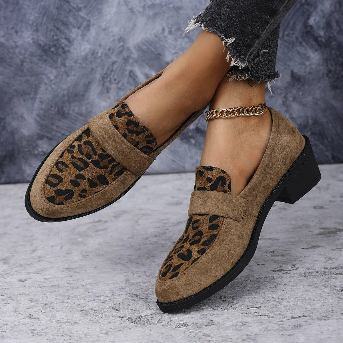 Leopard print suede slip-on shoes with a chunky mid heel and pointed toe on a rubber sole