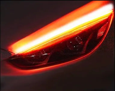 Car LED daytime running light strip with flowing turn signal indicators in silicone housing
