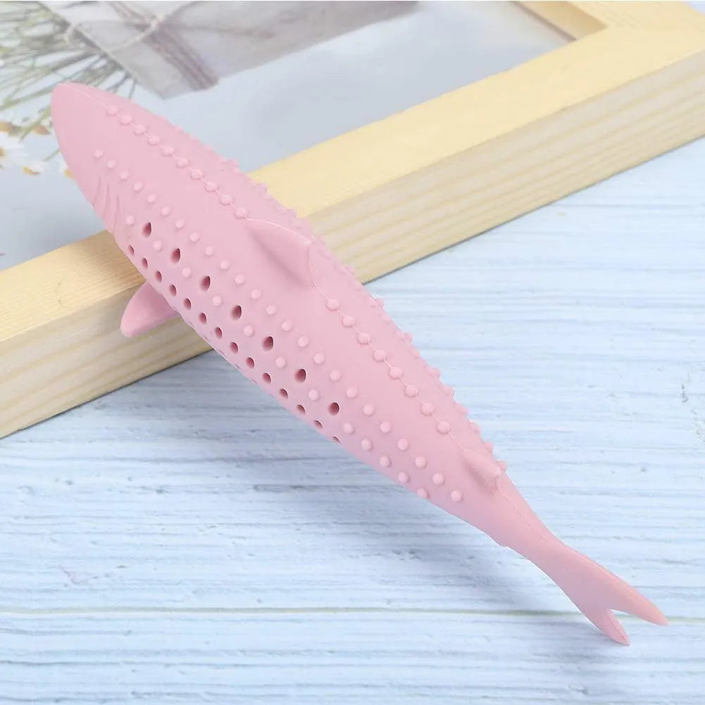 Green silicone dolphin-shaped cat chew toy on a white background, showing side air holes.