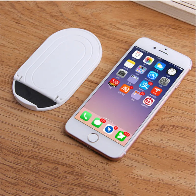 Plastic lazy bracket mobile phone stand in one of six colours: black, blue, grey, pink, white, or yellow.