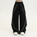 Black pleated wide-leg hip hop sports pants with stripe pattern laid flat