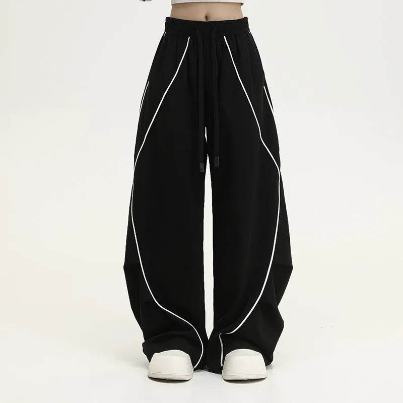 Black pleated wide-leg hip hop sports pants with stripe pattern laid flat