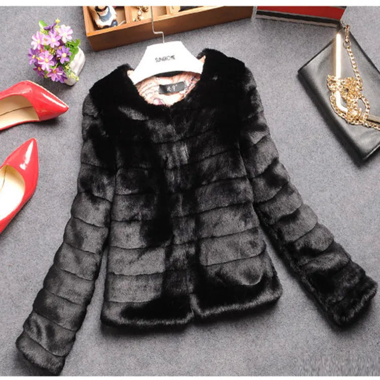 Women's short-length faux fur top in beige on a hanger, showing plush texture and regular sleeves.