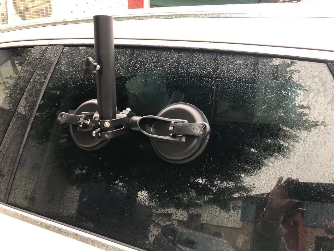 Black off-road car sucker mount with rubber suction cup for attaching flags to vehicle windows.