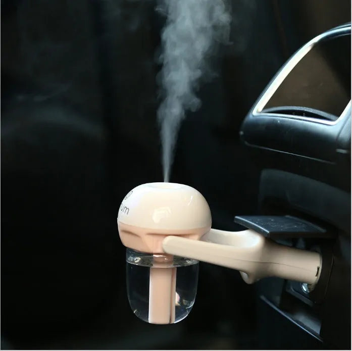 Compact blue car humidifier with rotating nozzle on a car dashboard