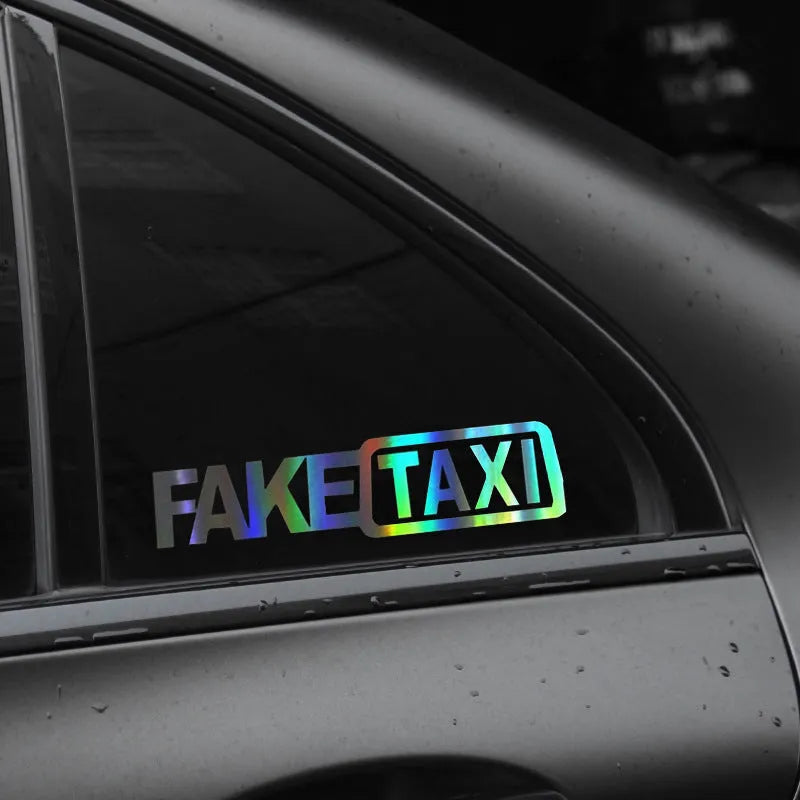 Black Fake Taxi car window sticker on glass, showing waterproof PET material and 20cm by 8cm size.