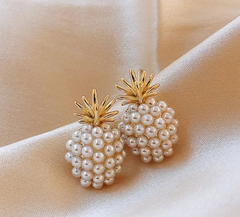 Women's gold electroplated alloy drop earrings with pineapple design and starfish pearl, featuring inlaid stones.