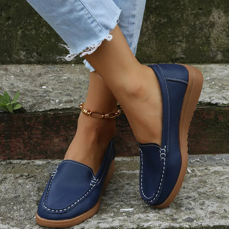 Women's flat slip-on loafers in soft PU leather shown in available colours with round toe and rubber sole