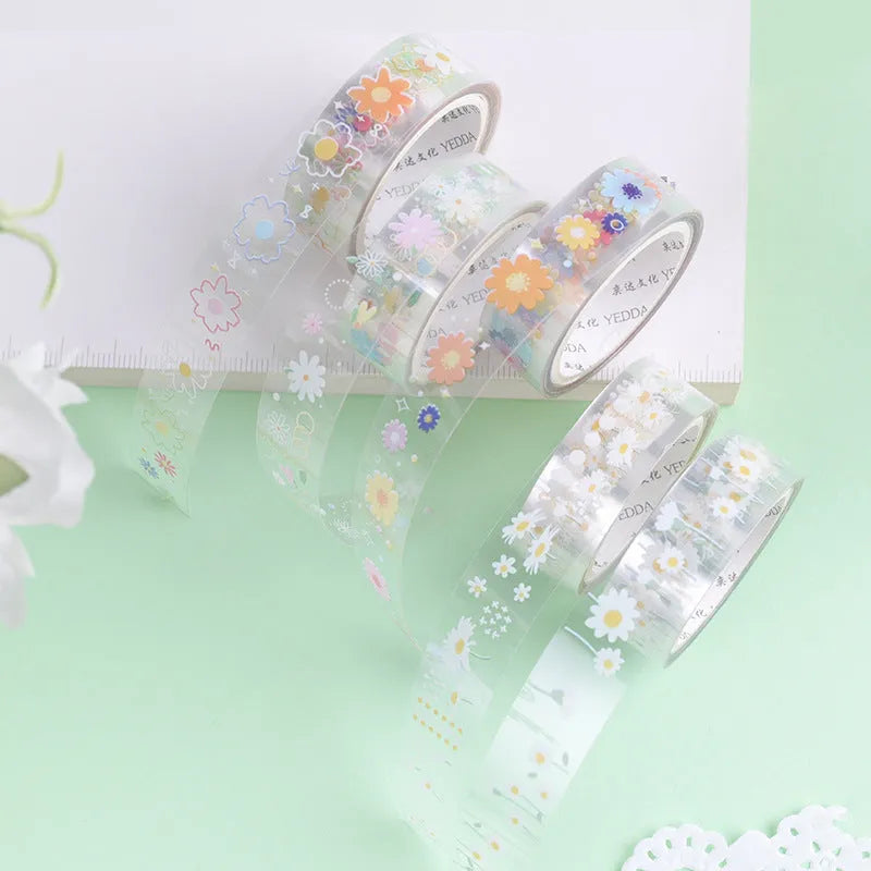 Five rolls of transparent adhesive tape with colourful daisy decoration on clear PET polyester backing