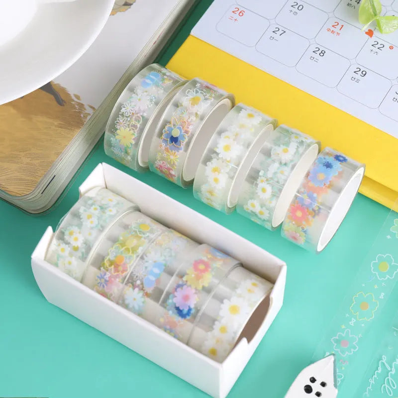 Five rolls of transparent adhesive tape with colourful daisy decoration on clear PET polyester backing