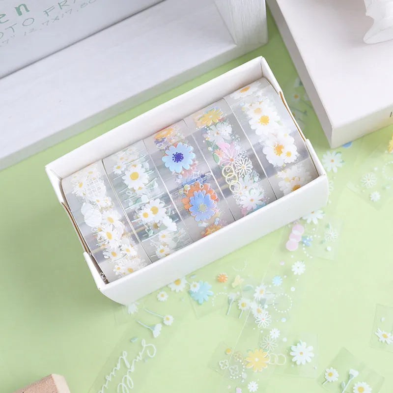 Five rolls of transparent adhesive tape with colourful daisy decoration on clear PET polyester backing