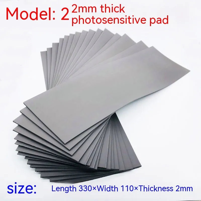 Black and gray plastic light-sensitive mat for seal pottery and calligraphy, showing 330mm by 110mm sheet.