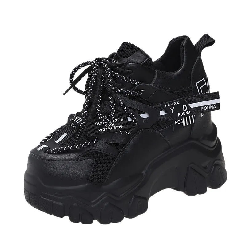 Women's white low-top platform tennis shoes with mesh upper and cross-strap detail on a rubber sole.