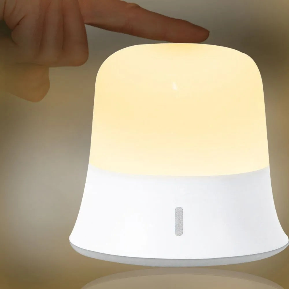 White cylindrical bedside night light with touch controls for dimming and colour changing