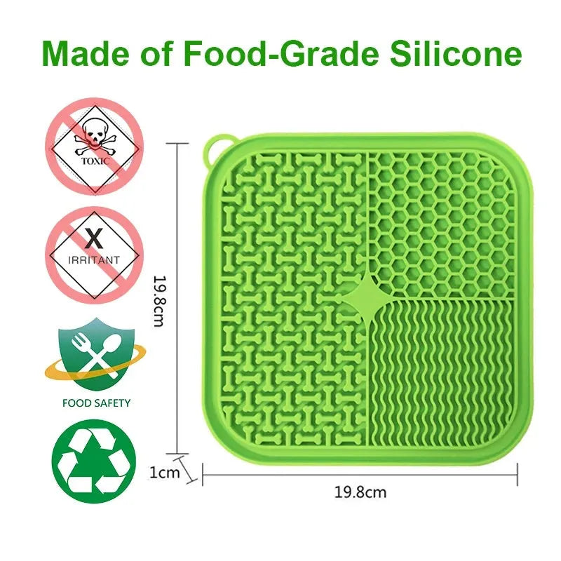 Blue silicone dog licking mat with textured surface and suction cups on a kitchen floor.