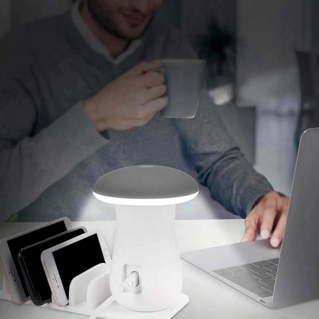White mushroom-shaped LED desk lamp with 5 USB charging ports on a wooden desk