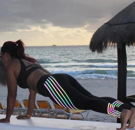 Women's black Milk Silk fitness leggings with night-glowing print, high-waisted pencil pants style.