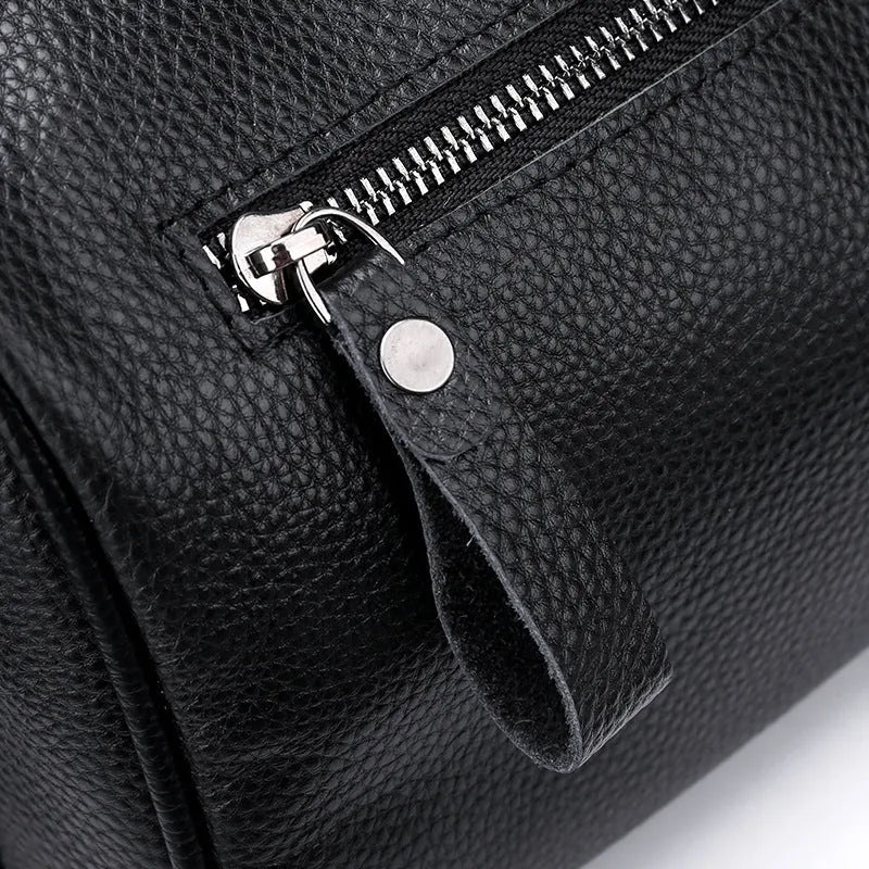 Black genuine leather one-shoulder crossbody bag showing 24x16x13cm dimensions and polyester lining interior