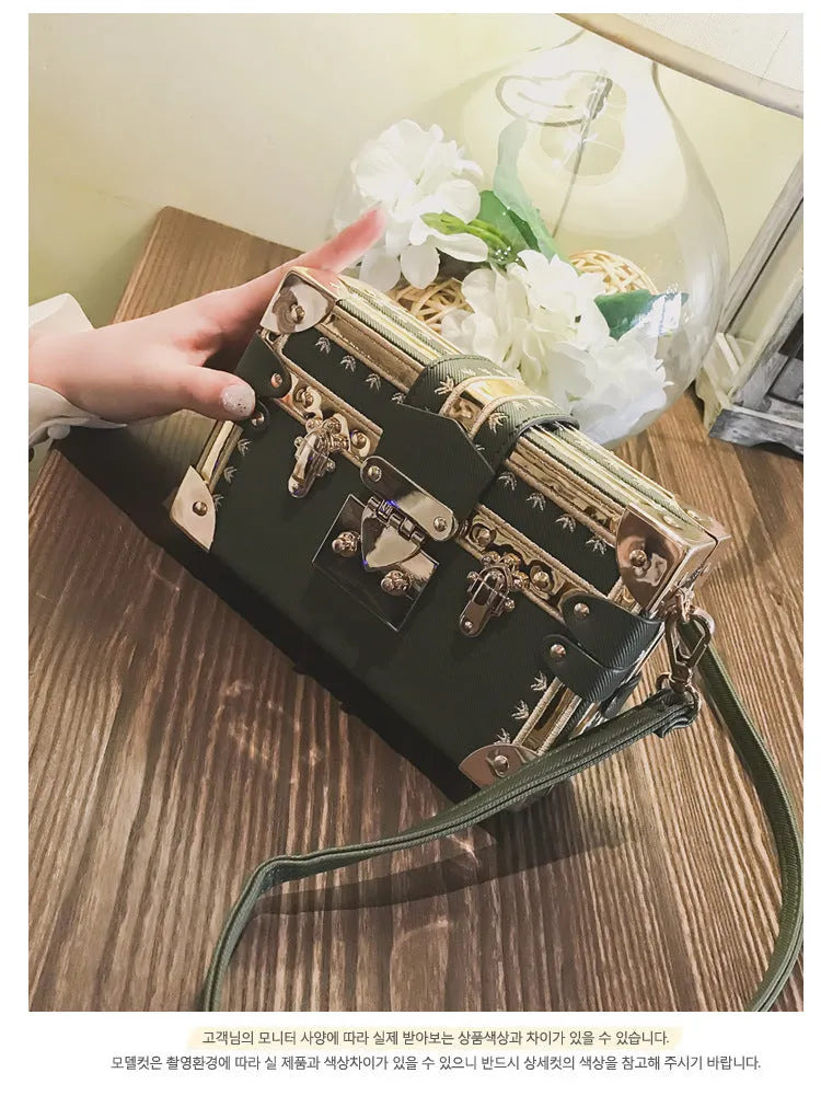 Black hard PU leather women's shoulder bag with flap, hasp closure, and rivet decoration.