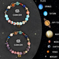 Two natural stone beaded bracelets showing zodiac sign designs on dark background