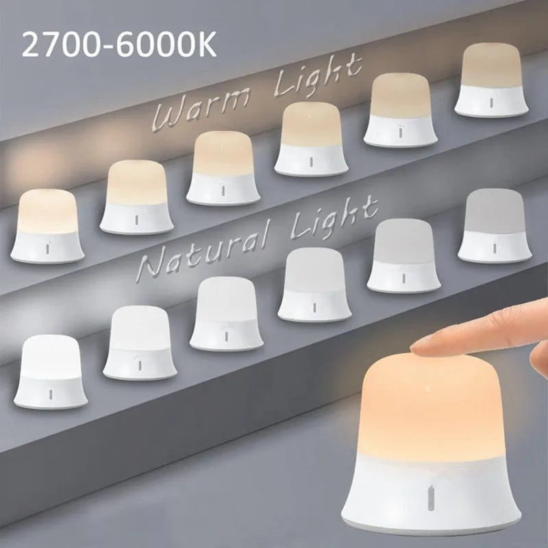 White cylindrical bedside night light with touch controls for dimming and colour changing