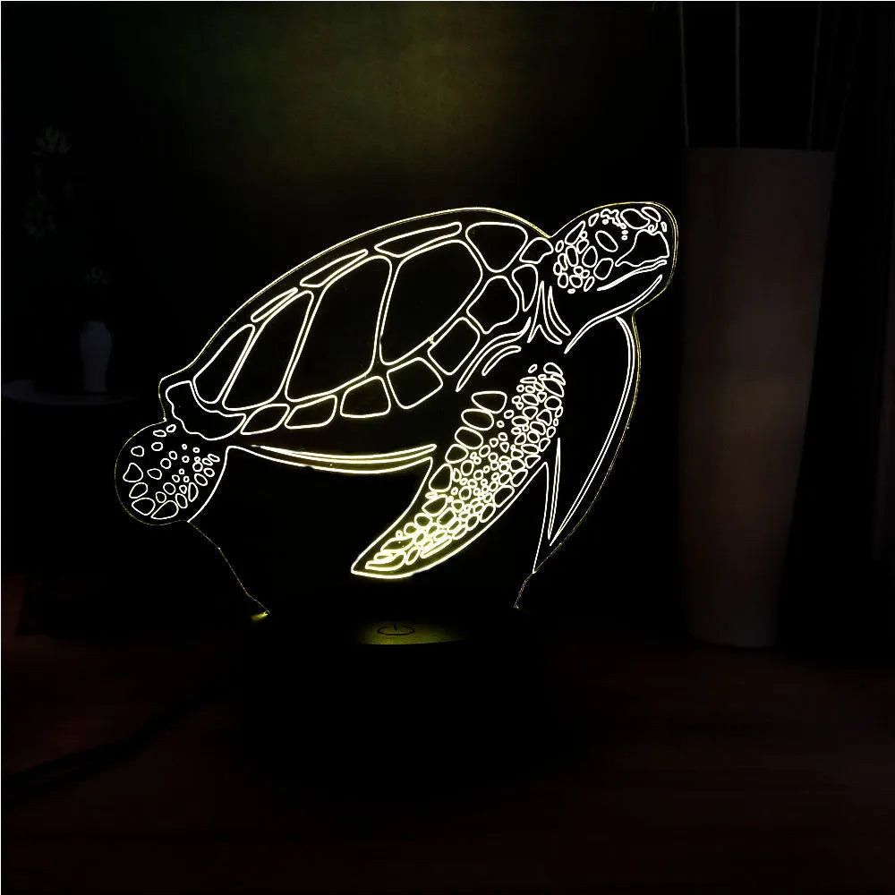 3D acrylic turtle-shaped LED night light with multi-colour glow on a surface.