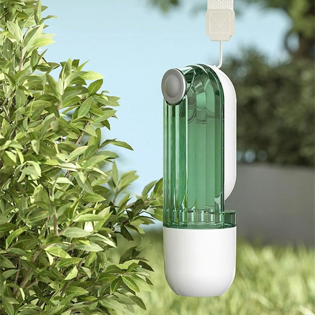 Beige and green foldable dog water bottle with food container, shown with press-to-dispense tray.