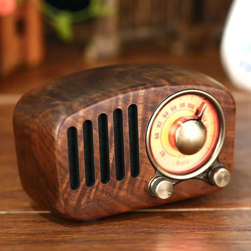 Retro wooden wireless mini speaker in cherry wood or walnut finish, showing compact size