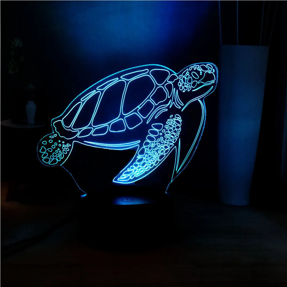 3D acrylic turtle-shaped LED night light with multi-colour glow on a surface.