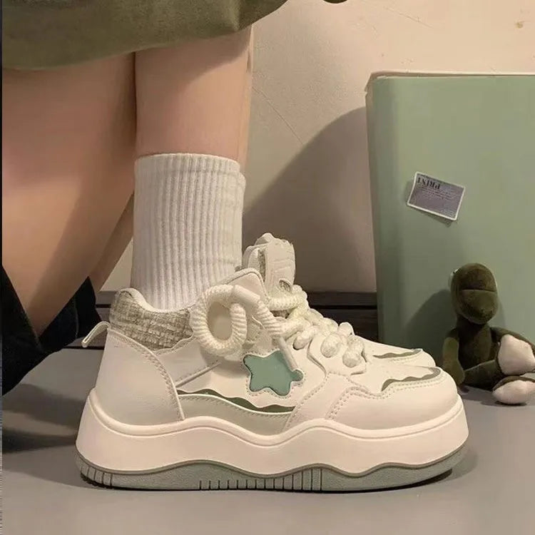 Women's green patent leather platform sneakers with round toe and lace-up front