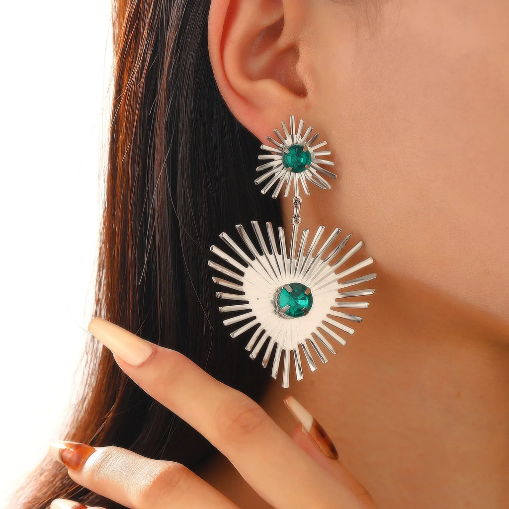 Alloy bohemian sunflower heart-shaped earrings with rhinestones in gold finish on white background