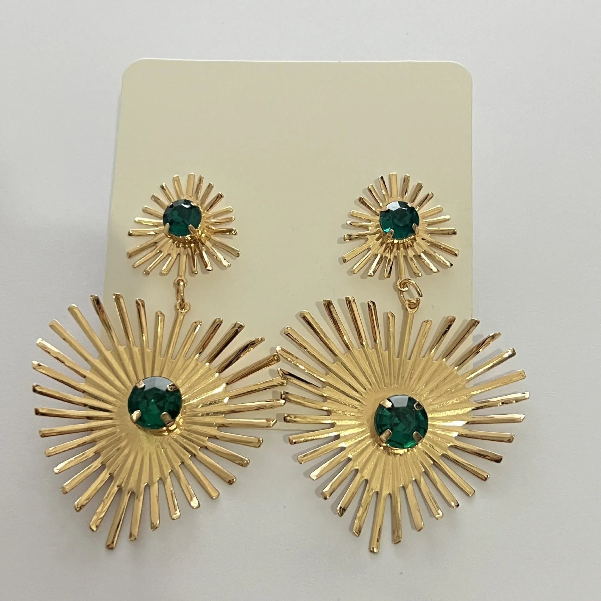 Alloy bohemian sunflower heart-shaped earrings with rhinestones in gold finish on white background