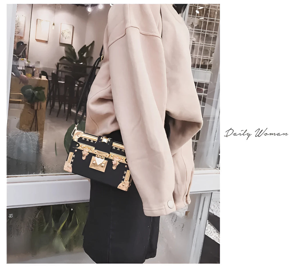 Black hard PU leather women's shoulder bag with flap, hasp closure, and rivet decoration.