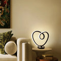 Black musical note-shaped Bluetooth LED light with app remote control on a bedside table.